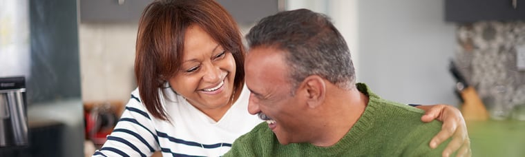 An African-American couple smiling at each other