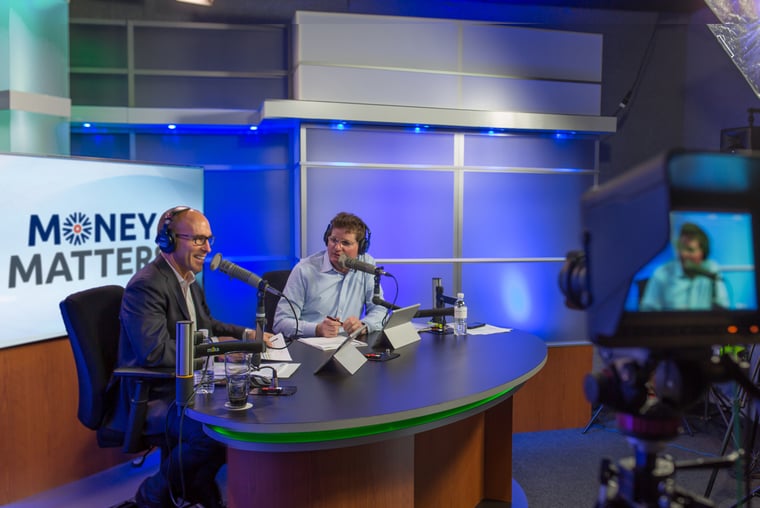 Money Matters podcast hosts Scott Hanson and Pat McClain sitting at a recording studio desk, discussing a caller's financial concerns