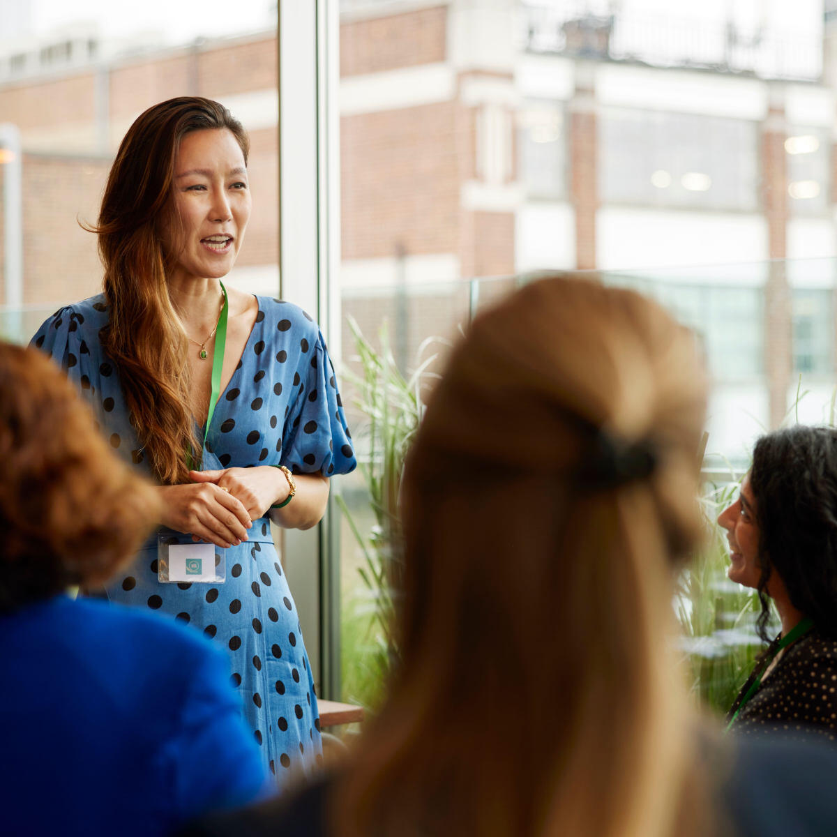 Woman speaking to audience about 401(k) 