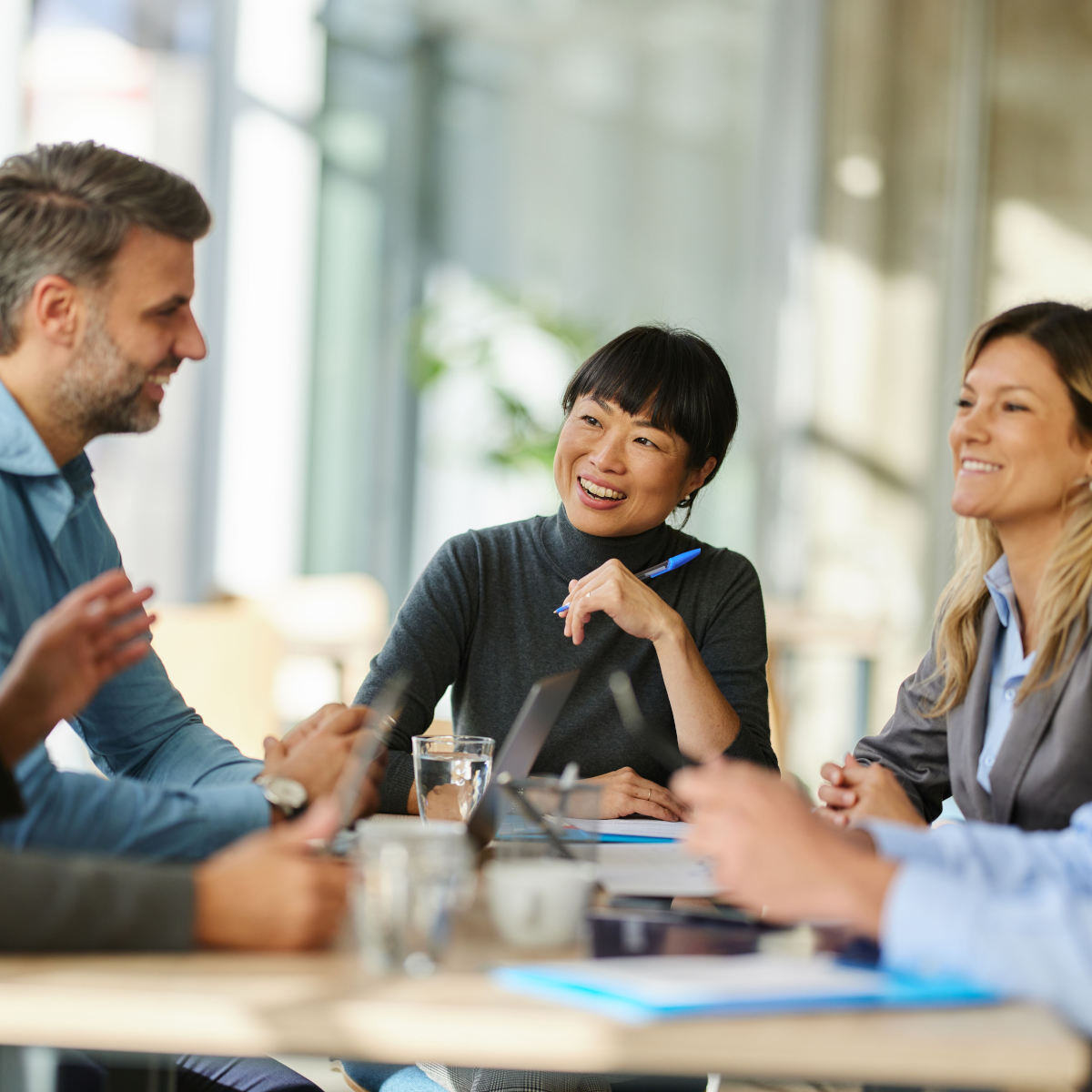Allworth woman sitting in a meeting with a team of financial professionals