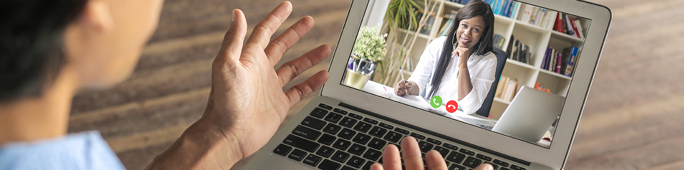 A woman financial advisor talking with a prospective client on a video conference call.